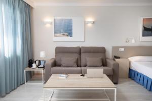 a living room with a couch and a bed at Prestige Mar y Sol in Roses +74 photos