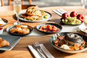 a wooden table with plates of food on it at Blue Harbour Boutique in Ayia Napa