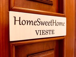 a sign on a door with the words home sweet home vibe at home sweet home vieste in Vieste