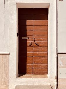a wooden door on the side of a building at home sweet home vieste in Vieste