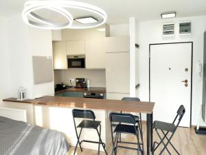 a kitchen with a table and chairs in a room at Forest Hill apartment in Budapest