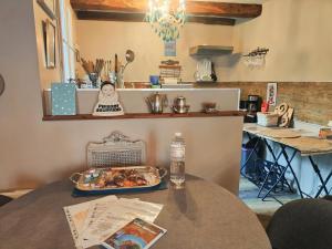 a kitchen with a table with a tray of food on it at Ty Brigitte in Dinan
