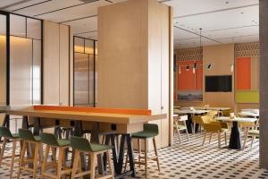 a conference room with tables and chairs and a table at Home2 Suites by Hilton Beijing West Station in Beijing