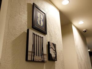 a group of pictures hanging on a wall at Hotel La Foresta By Rigna in Fukuoka