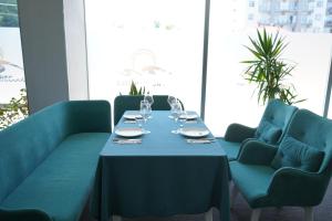 a table with wine glasses on it in a room at RUMI Hotel in Batumi