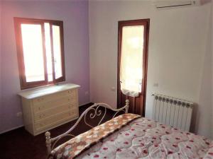 a bedroom with a bed and a dresser and a window at Relax immersed within the Sette Fratelli Mountains in San Gregorio