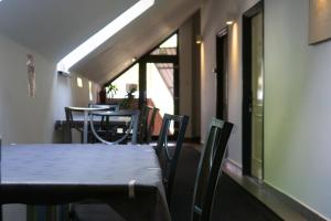 a dining room with a table and chairs in a room at Megacentrum Szállás in Szekszárd