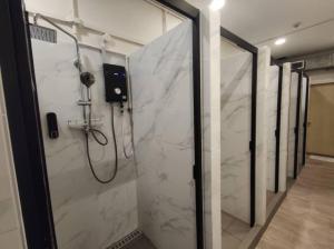 a bathroom with a shower with white marble at BEAT Arts Hostel at Chinatown in Singapore