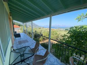 a balcony with a table and chairs on it at Thalia’s Mountain View in Palaiokatoúna