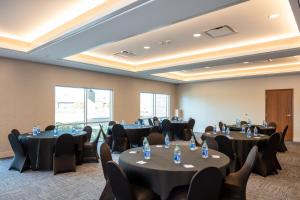 a conference room with round tables and chairs at Holiday Inn Express & Suites - Beloit, an IHG Hotel in Beloit