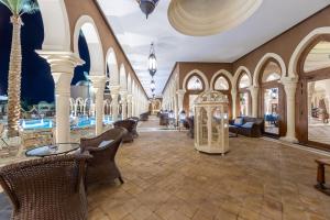 a lobby of a resort with chairs and a clock at Grand Makadi - Couples and Families Only in Hurghada