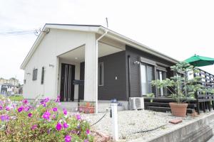 een huis met bloemen ervoor bij Awaji Riverside Terrace in Shizuki 780 in Shizuki