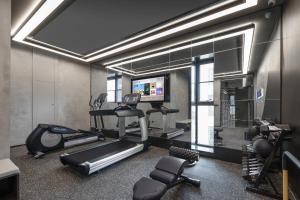 a room with a gym with a treadmill and a television at Atour Hotel Dali Erhai Park in Dali