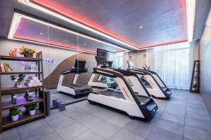 a gym with several treadmill machines in a room at Atour Hotel Jincheng Gaoping High-Speed East Railway Station in Gaoping