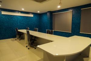 a conference room with a white table and chairs at RV STAY INN in Yelahanka