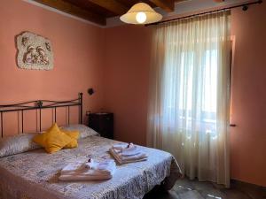 a bedroom with a bed with two towels on it at Borgo delle Panie in Careggine