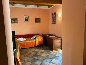 a small bedroom with a bed and a table at Borgo delle Panie in Careggine