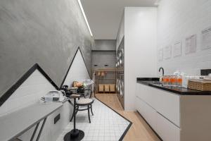 a kitchen with a counter and a chair in a room at Atour Hotel Dali Erhai Park in Dali