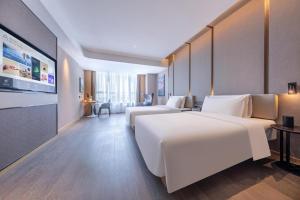 Ένα ή περισσότερα κρεβάτια σε δωμάτιο στο Atour Hotel Xuzhou Pei County Dongfeng Road