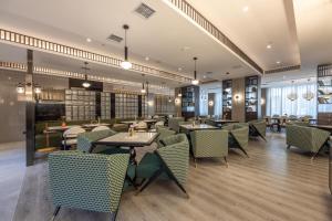 a restaurant with tables and chairs in a room at Atour Hotel Lanzhou Railway Bureau in Lanzhou