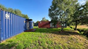 a home with a yard with two shipping containers at Arche Siedlisko Piłka Boisko 