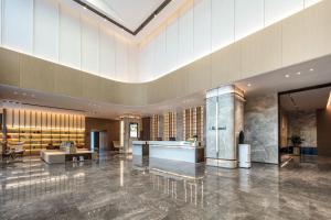 a lobby of a hotel with a large ceiling at Atour Hotel Hangzhou East Railway Station West Square in Hangzhou