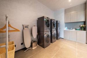 a kitchen with three washing machines in a room at Atour Hotel Shanwei High-Speed Railway Station Binhai Park in Shanwei