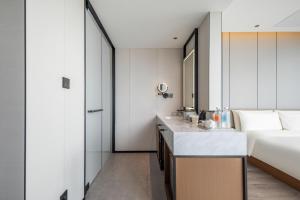 a hotel room with a bed and a sink at Atour Hotel Dali Erhai Park in Dali +72 photos
