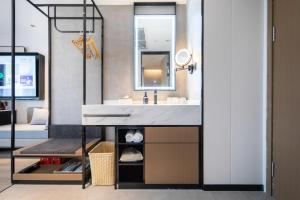 a bathroom with a sink and a mirror at Atour Hotel Suqian Industrial Park Wuyue Plaza in Suqian +17 photos