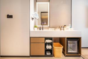 a bathroom with a sink and a mirror at Atour Hotel Kunming Guangfu Road Haile World in Kunming
