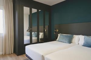 Posteľ alebo postele v izbe v ubytovaní Arenas Atiram Hotel