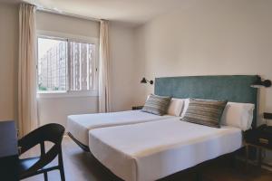 Posteľ alebo postele v izbe v ubytovaní Arenas Atiram Hotel