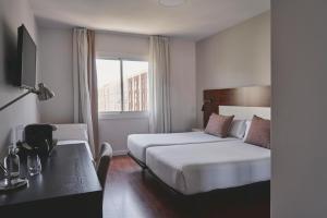 Posteľ alebo postele v izbe v ubytovaní Arenas Atiram Hotel