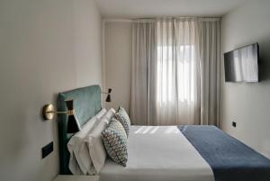 Posteľ alebo postele v izbe v ubytovaní Arenas Atiram Hotel