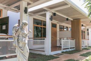 an angel statue stands in front of a house at Best Way Resort in Pak Chong