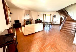a living room with a couch and a fireplace at Villa Rina in Avola