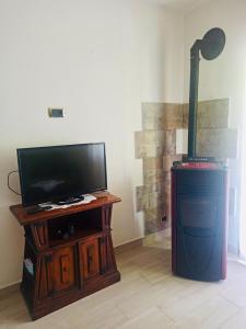 a living room with a flat screen tv and a fireplace at Casa Tatone in Roccaraso