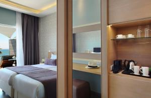 a hotel room with a bed and a window at Royal Apollonia by Louis Hotels in Limassol