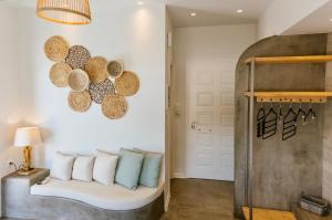 a room with a bed with pillows and a lamp at Ammos Luxury Suite in Karistos