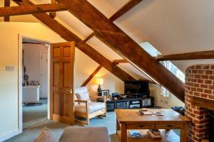 a living room with wooden ceilings and a table at Finest Retreats - Valley View in Camelford