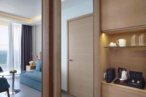 a room with a door leading to a room with a bed at Royal Apollonia by Louis Hotels in Limassol