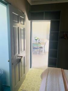 an open door to a room with a table at Doornboom Farm Self Service in Heidelberg