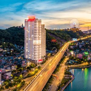 a tall building with a ferris wheel on top of it at Ramada Hotel & Suites by Wyndham Halong Bay View in Ha Long