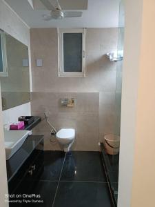 a bathroom with a toilet and a sink at Dynamic Room(R3) Embellished with Excellence-Heart of City in New Delhi