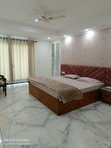 a bedroom with a large bed and a ceiling at Dynamic Room(R3) Embellished with Excellence-Heart of City in New Delhi