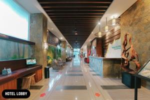 a lobby of a restaurant with a long hallway at Grand Ixora Kuta Resort in Kuta