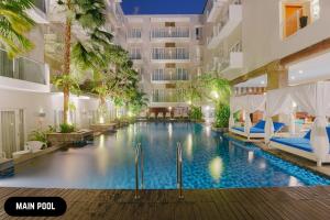 an image of a swimming pool in a hotel at Grand Ixora Kuta Resort in Kuta