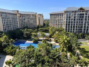an aerial view of a resort with palm trees and buildings at Zhongzhou International Apartment in Sanya