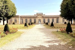 um grande edifício com um caminho à sua frente em Appartement en coeur de village em Bourg-sur-Gironde