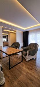 a living room with two couches and a coffee table at Apartamenty Rzucewska 87 in Żelistrzewo